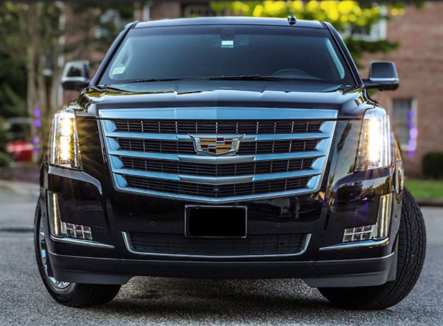 black Cadillac Escalade parked in a driveway