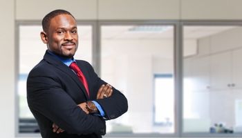 black man in business suit with his arms crossed