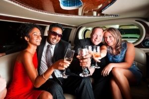 group of business people celebrating in a limo
